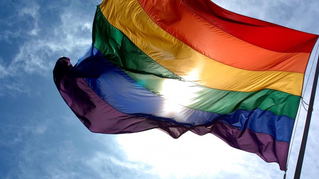 Rainbow_flag_and_blue_skies.jpg